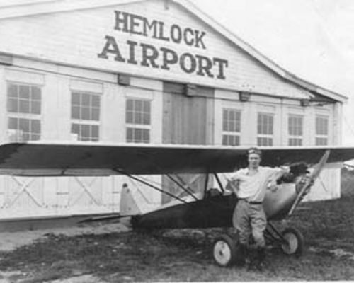 Glenn Johnston with his experimental plane at Hemlock Airport, 1932